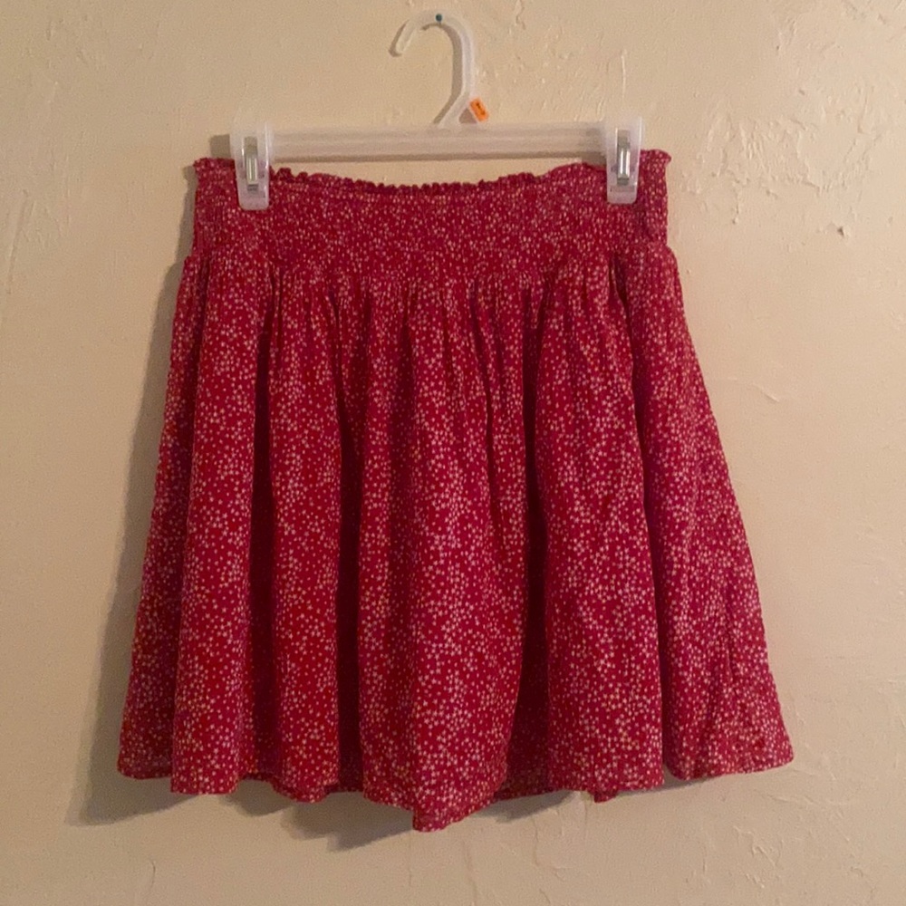 Knee length red skirt with white stars.